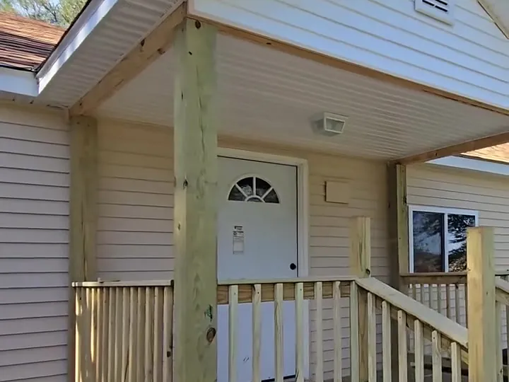 New covered porch with wood railings